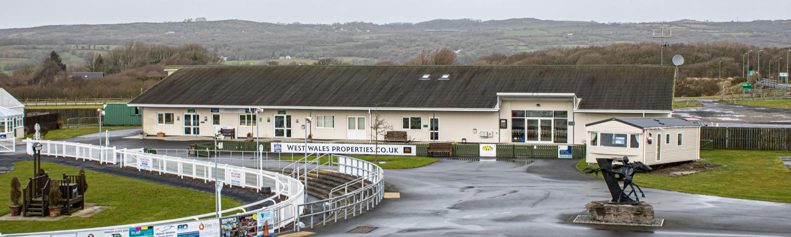 Owners & Trainers Bar and the Weighing Room building next to the parade ring at Ffos Las Racecourse.