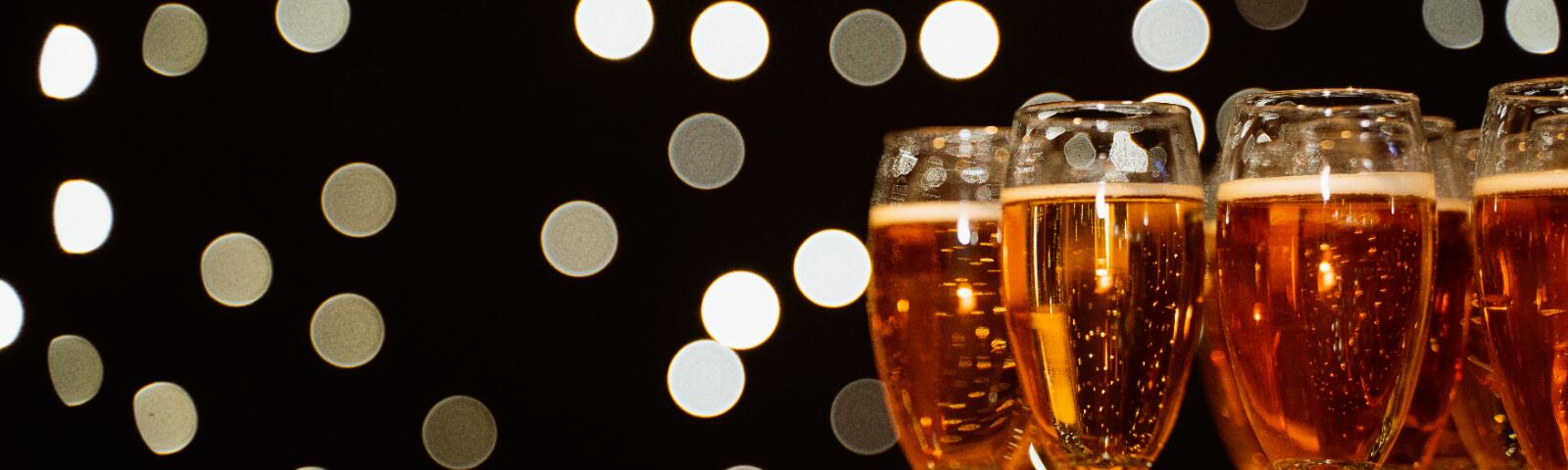 Glasses of champagne in front of a twinkly back drop