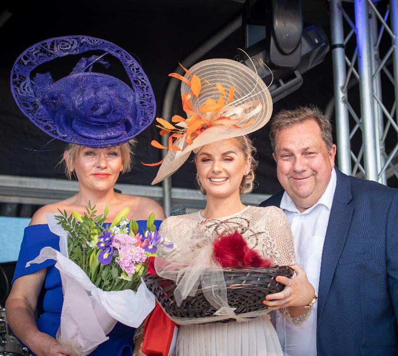 Winner of the Ladies Day competition poses with her prize