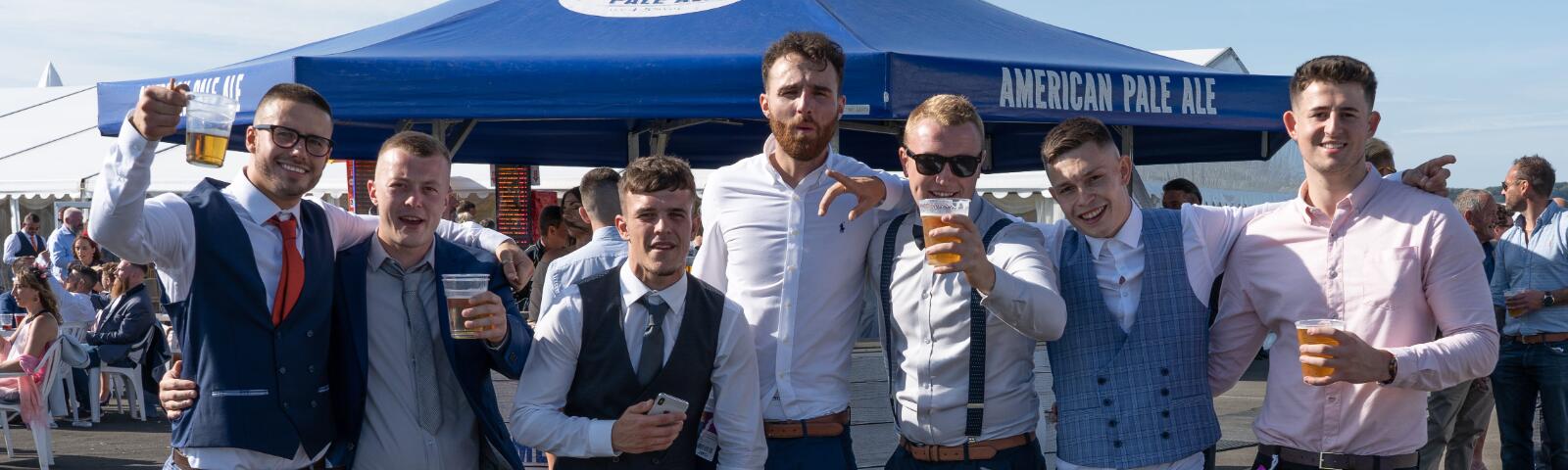 A large group of smartly dressed guys at Ffos Las Racecourse
