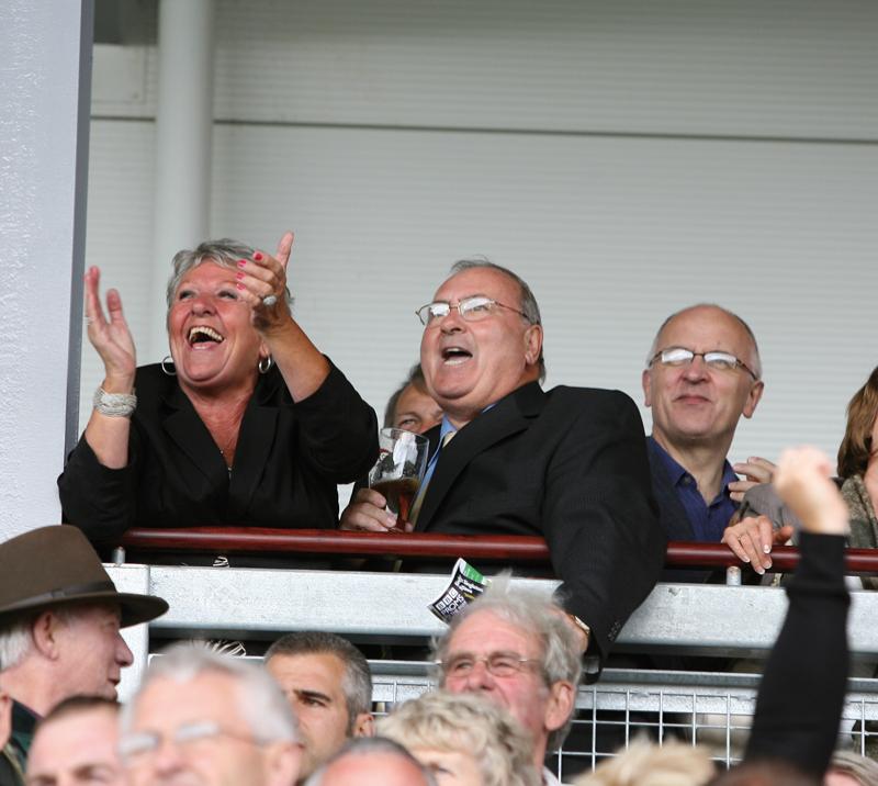 Racegoers cheering on from the grandstand at Ffos Las Racecourse.