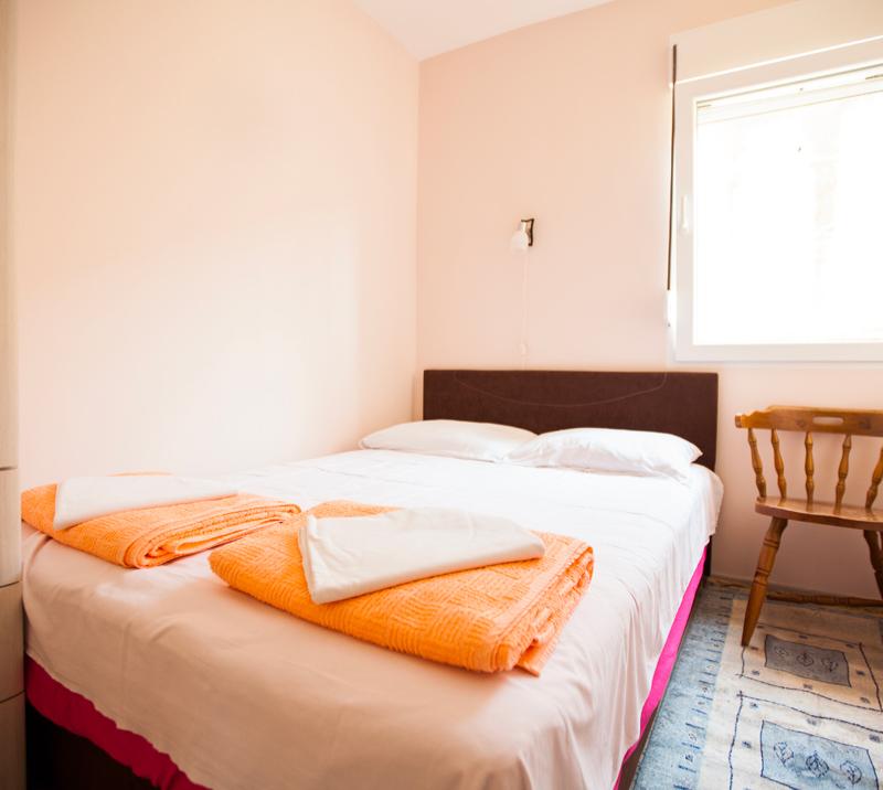 Interior of a room, with a double bed.